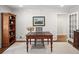 Well-lit home office with a vintage desk, bookcase, and neutral decor at 4643 River Ct, Peachtree Corners, GA 30097