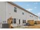 Townhome's back patio with seating area enclosed by a wooden fence offering privacy at 5575 Rock Place Ct, Norcross, GA 30093