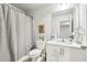 Bright bathroom with a modern vanity, toilet, and a shower with curtain at 5575 Rock Place Ct, Norcross, GA 30093