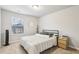 Well-lit bedroom with a bed, nightstand, modern lamp, and a window with natural light at 5575 Rock Place Ct, Norcross, GA 30093