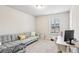 Relaxing bedroom with large window and a gray sofa, ideal for a home office at 5575 Rock Place Ct, Norcross, GA 30093