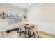Bright dining room featuring a table with six chairs and wainscoting details at 5575 Rock Place Ct, Norcross, GA 30093