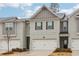 Charming townhome featuring a two-car garage, neutral brick, and well-maintained landscaping at 5575 Rock Place Ct, Norcross, GA 30093
