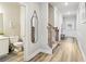 Inviting hallway featuring hardwood floors, a staircase, and access to a half bathroom at 5575 Rock Place Ct, Norcross, GA 30093