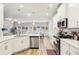 Bright, open kitchen with stainless steel appliances and modern countertops, seamlessly flowing into dining and living areas at 5575 Rock Place Ct, Norcross, GA 30093