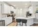 Well-lit kitchen featuring white cabinets, stainless steel appliances, and a breakfast bar at 5575 Rock Place Ct, Norcross, GA 30093