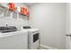 Functional laundry area with modern washer and dryer and wire shelving above at 5575 Rock Place Ct, Norcross, GA 30093