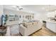 Bright living room featuring a large sectional sofa, wood floors, and a ceiling fan at 5575 Rock Place Ct, Norcross, GA 30093