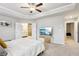 Spacious main bedroom with a tray ceiling, ceiling fan, and access to a luxurious ensuite bathroom at 5575 Rock Place Ct, Norcross, GA 30093