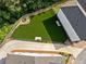 Aerial view of fenced backyard with lush artificial turf at 677 Stickley Oak Way, Woodstock, GA 30189