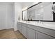 Bathroom with dual sinks, large mirror, and decorative plants at 677 Stickley Oak Way, Woodstock, GA 30189