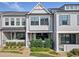 Well-maintained townhome with covered porch and manicured landscaping at 677 Stickley Oak Way, Woodstock, GA 30189