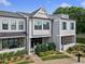 Charming townhome with beautifully landscaped front yard and covered porch at 677 Stickley Oak Way, Woodstock, GA 30189