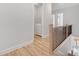 Hallway features a staircase with black iron railings leading to the laundry room with modern appliances at 677 Stickley Oak Way, Woodstock, GA 30189