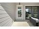 Cozy outdoor patio with seating area and sliding door access to the interior at 677 Stickley Oak Way, Woodstock, GA 30189