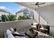 Private patio with comfortable seating, ceiling fan, and views of nearby homes at 677 Stickley Oak Way, Woodstock, GA 30189