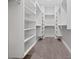 Spacious walk-in closet with multiple shelves and racks for ample storage at 677 Stickley Oak Way, Woodstock, GA 30189