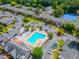 Aerial view of community amenities including a pool and tennis courts, surrounded by residential buildings at 6851 Roswell Rd # O-26, Atlanta, GA 30328