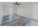 Bedroom with two windows, ceiling fan, and hard surface floors at 6851 Roswell Rd # O-26, Atlanta, GA 30328