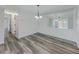 Bright dining room featuring hardwood floors, contemporary lighting, and a large mirror at 6851 Roswell Rd # O-26, Atlanta, GA 30328