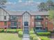 Charming condo building with brick facade, black trim, and balcony access on the second floor at 6851 Roswell Rd # O-26, Atlanta, GA 30328