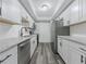 Modern kitchen featuring white cabinets, granite countertops, stainless steel appliances, and wood floors at 6851 Roswell Rd # O-26, Atlanta, GA 30328