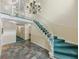 Inviting lobby area with stairs, tiled floor, chandelier, and neutral walls at 6851 Roswell Rd # O-26, Atlanta, GA 30328