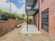 Private patio with brick wall, stone bench, and tile flooring with sliding glass door access to the interior at 6851 Roswell Rd # O-26, Atlanta, GA 30328