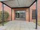 View of tiled patio area with sliding glass door, providing access to the brick building at 6851 Roswell Rd # O-26, Atlanta, GA 30328