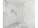 Modern glass shower stall with white marble-style tile and updated shower head at 6851 Roswell Rd # O-26, Atlanta, GA 30328