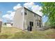 Two-story home showcasing vinyl siding, well-kept lawn, and a modest back patio at 1647 Shire Village Dr, Sugar Hill, GA 30518