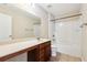 Bathroom featuring vanity with storage, shower-tub, and a large mirror at 1647 Shire Village Dr, Sugar Hill, GA 30518