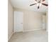 Carpeted bedroom featuring a ceiling fan and neutral walls at 1647 Shire Village Dr, Sugar Hill, GA 30518