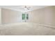 Bright bedroom featuring neutral walls, carpet flooring, and a ceiling fan for added comfort at 1647 Shire Village Dr, Sugar Hill, GA 30518