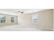Large carpeted bedroom with bright windows and a ceiling fan for added comfort at 1647 Shire Village Dr, Sugar Hill, GA 30518