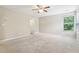 Bright bedroom featuring neutral walls, carpet flooring, ceiling fan and natural light from a window at 1647 Shire Village Dr, Sugar Hill, GA 30518