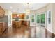 Eat-in kitchen featuring granite countertops, stainless appliances, and hardwood floors at 1647 Shire Village Dr, Sugar Hill, GA 30518