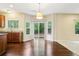 Bright breakfast area in kitchen with backyard views from the sliding glass door at 1647 Shire Village Dr, Sugar Hill, GA 30518