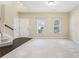 Bright living room featuring two windows, neutral walls, and plush carpeted floors at 1647 Shire Village Dr, Sugar Hill, GA 30518