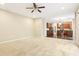 Open-concept living room showcasing an adjoining kitchen with wood floors and stainless steel appliances at 1647 Shire Village Dr, Sugar Hill, GA 30518