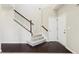 Well-lit staircase with wood railing, carpeted steps, and hardwood landing at 1647 Shire Village Dr, Sugar Hill, GA 30518