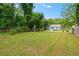 Large backyard with lush lawn and mature trees, offering plenty of space for outdoor activities at 1798 S Gordon Sw St, Atlanta, GA 30310