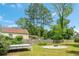 Backyard featuring mature trees, a circular fire pit area, a deck, and a fenced perimeter at 1798 S Gordon Sw St, Atlanta, GA 30310