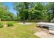 Spacious backyard features a large grassy area, fire pit, and mature trees at 1798 S Gordon Sw St, Atlanta, GA 30310