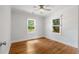 This bedroom features hardwood floors, two windows that let in natural light, and a ceiling fan at 1798 S Gordon Sw St, Atlanta, GA 30310