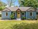 Charming bungalow with blue painted brick, yellow front door, tidy landscaping and a new roof at 1798 S Gordon Sw St, Atlanta, GA 30310