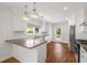Bright kitchen features white cabinets, stainless steel appliances, and hardwood floors at 1798 S Gordon Sw St, Atlanta, GA 30310