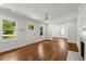Living room with hardwood floors, white trim, and sunlit doorway to the backyard at 1798 S Gordon Sw St, Atlanta, GA 30310