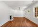 Bright living room boasts hardwood floors, modern ceiling fan, fireplace, and large windows for natural light at 1798 S Gordon Sw St, Atlanta, GA 30310