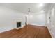 Spacious living room with hardwood floors, white walls, a modern ceiling fan and a decorative fireplace at 1798 S Gordon Sw St, Atlanta, GA 30310